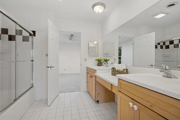 a spacious bathroom with a shower sink and mirror