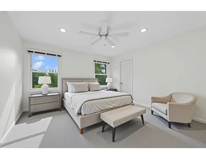 a spacious bedroom with a bed and a couch