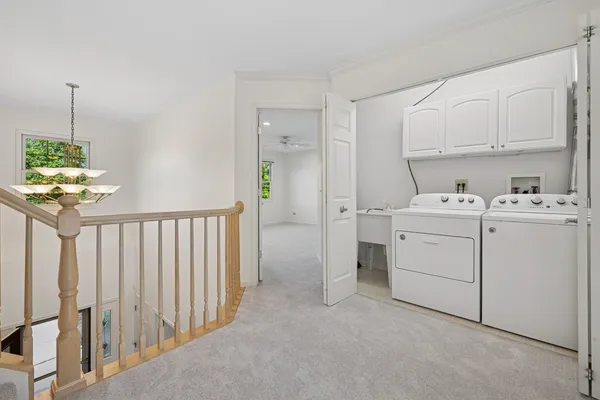 a utility room with cabinets washer and dryer