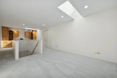 a view of a livingroom with furniture and a kitchen