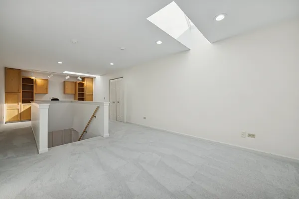 a view of a livingroom with furniture and a kitchen