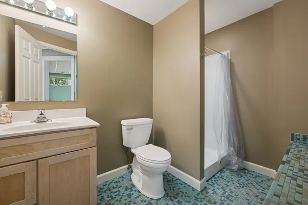 a bathroom with a sink a toilet and a mirror