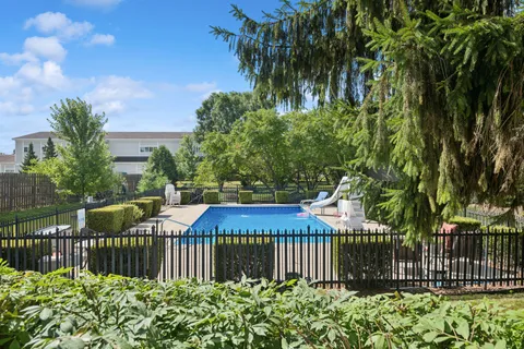 a view of a house with a small yard and plants