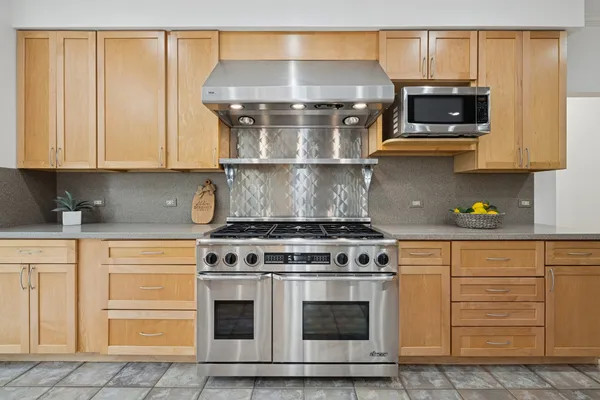 a stove top oven sitting inside of a kitchen