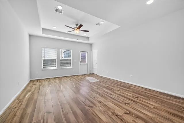 wooden floor in an empty room with a window