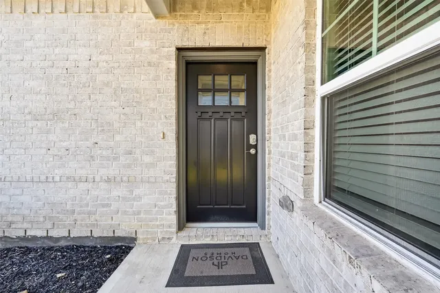 a view of a wooden door with a bench