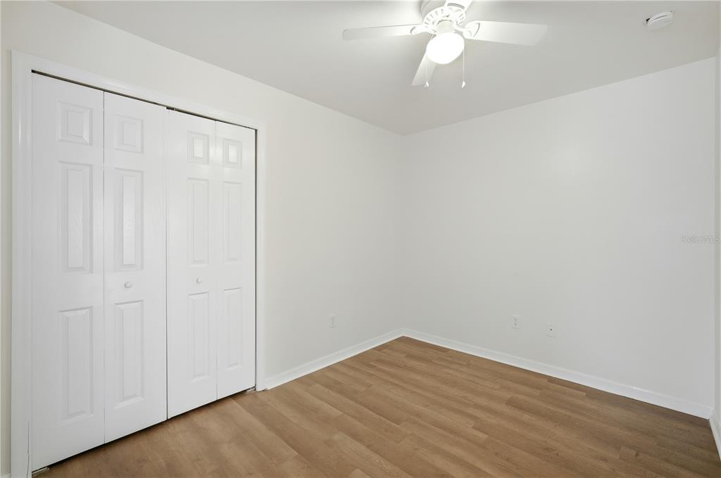 5002 Beechcraft Way Seffner, FL 33584 - Photo 11 of 26 a view of an empty room with wooden floor and a window