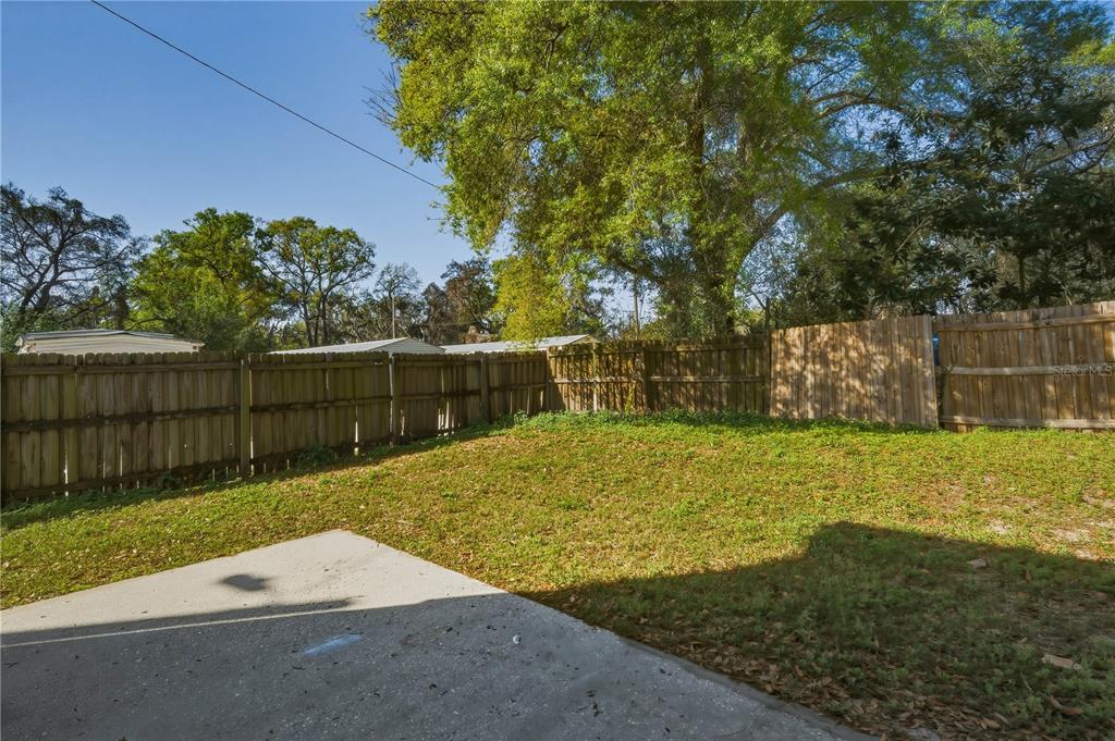 5002 Beechcraft Way Seffner, FL 33584 - Photo 20 of 26 a view of a backyard with wooden fence
