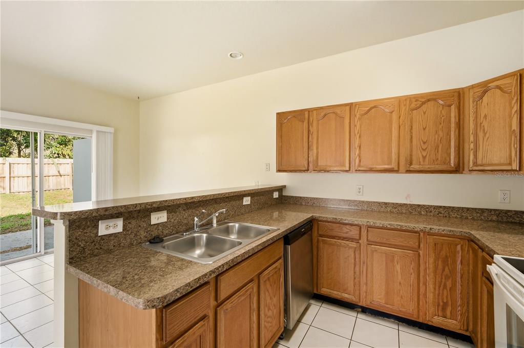 5002 Beechcraft Way Seffner, FL 33584 - Photo 7 of 26 a kitchen with a sink and cabinets