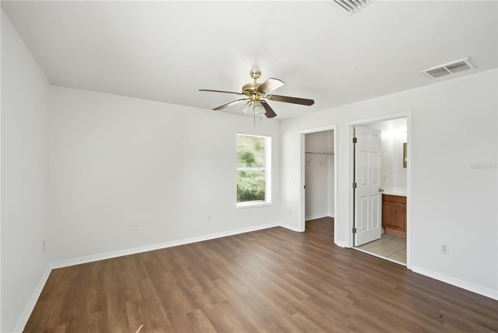 5002 Beechcraft Way Seffner, FL 33584 - Photo 9 of 26 wooden floor in an empty room with a window