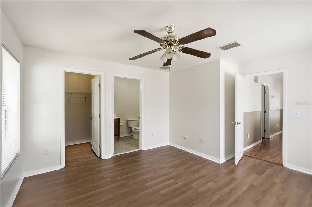 5002 Beechcraft Way Seffner, FL 33584 - Photo 10 of 26 a view of a big room with wooden floor and windows