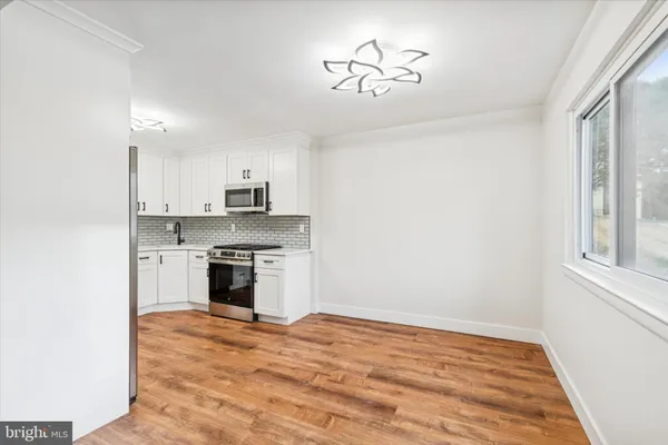 a view of a kitchen with a stove cabinets and a wooden floor