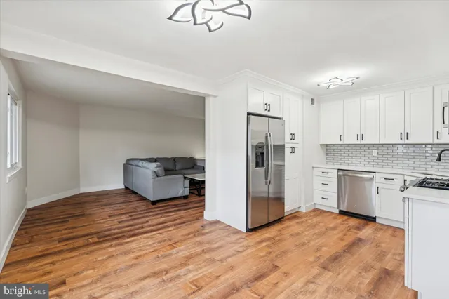 a kitchen with stainless steel appliances a refrigerator and cabinets
