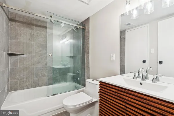 a bathroom with a sink a toilet and a bathtub