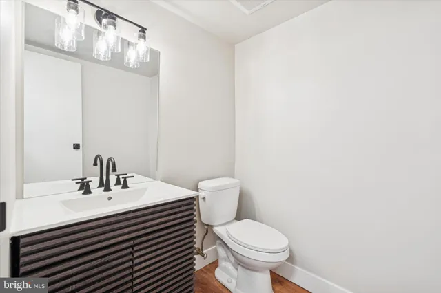a bathroom with a sink a toilet and mirror