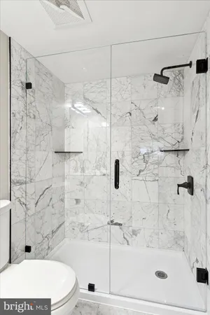 a bathroom with a toilet and shower