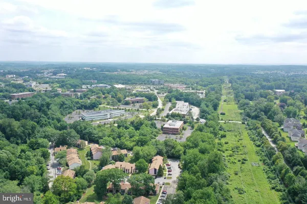 an aerial view of a house with yard and outdoor seating