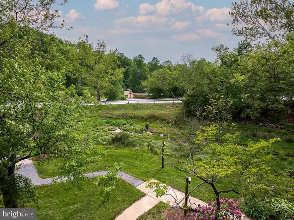 a view of yard with swimming pool and green space
