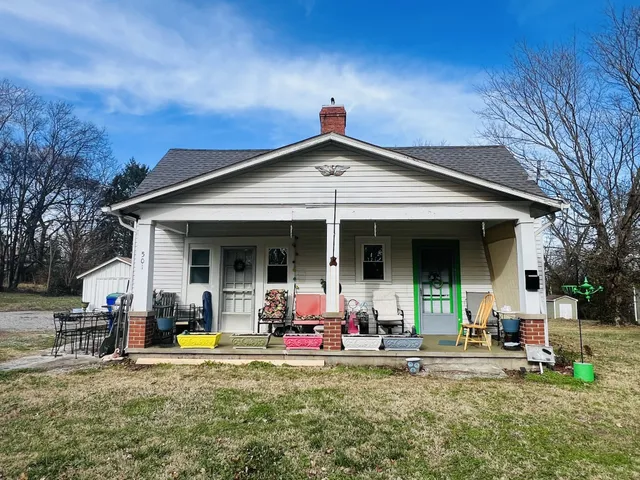 a view of a house with backyard porch and furniture