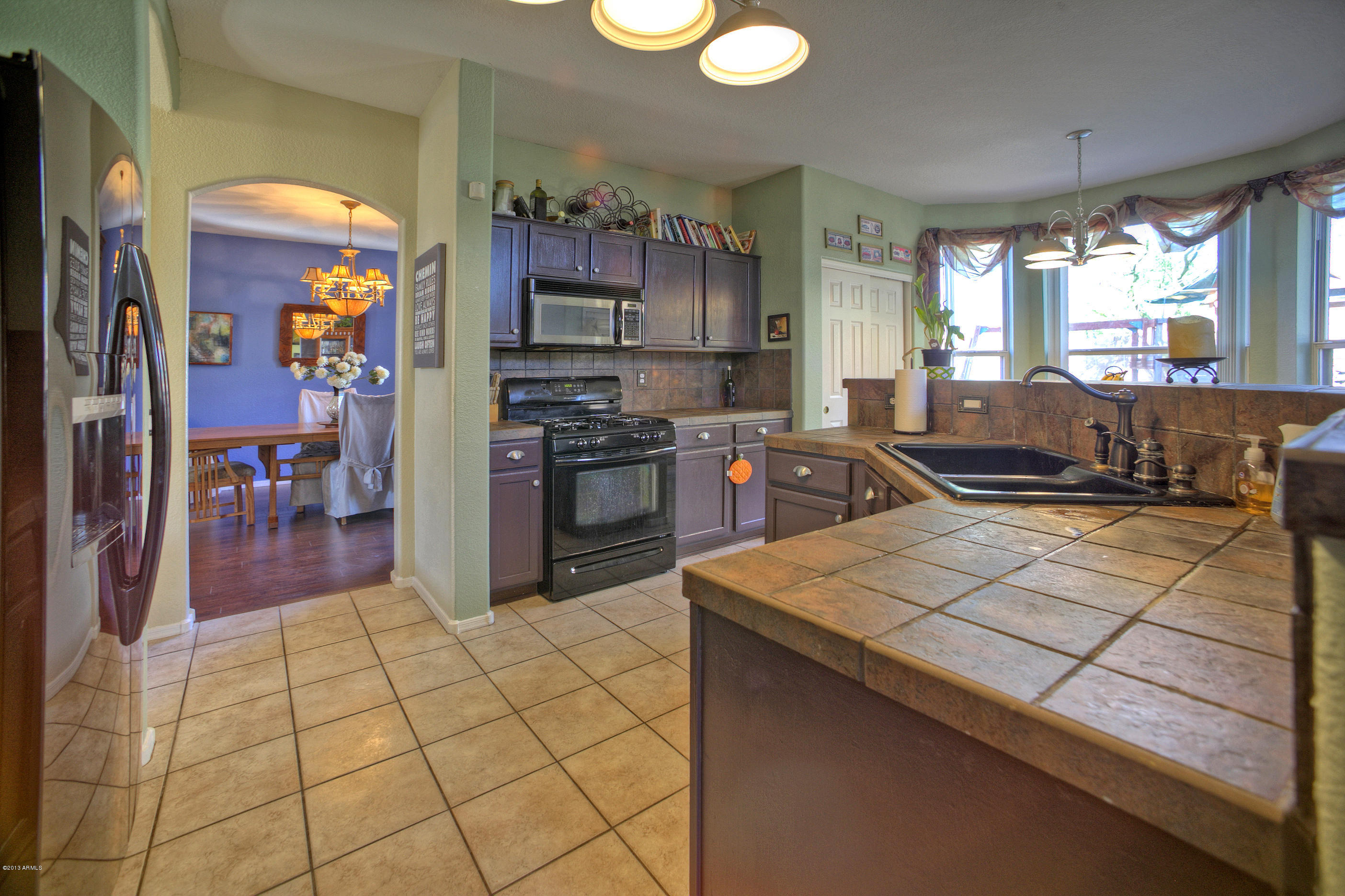 4510 East Rowel Road Phoenix, AZ 85050 - Photo 11 of 29 a kitchen with stainless steel appliances granite countertop a stove a sink and a refrigerator