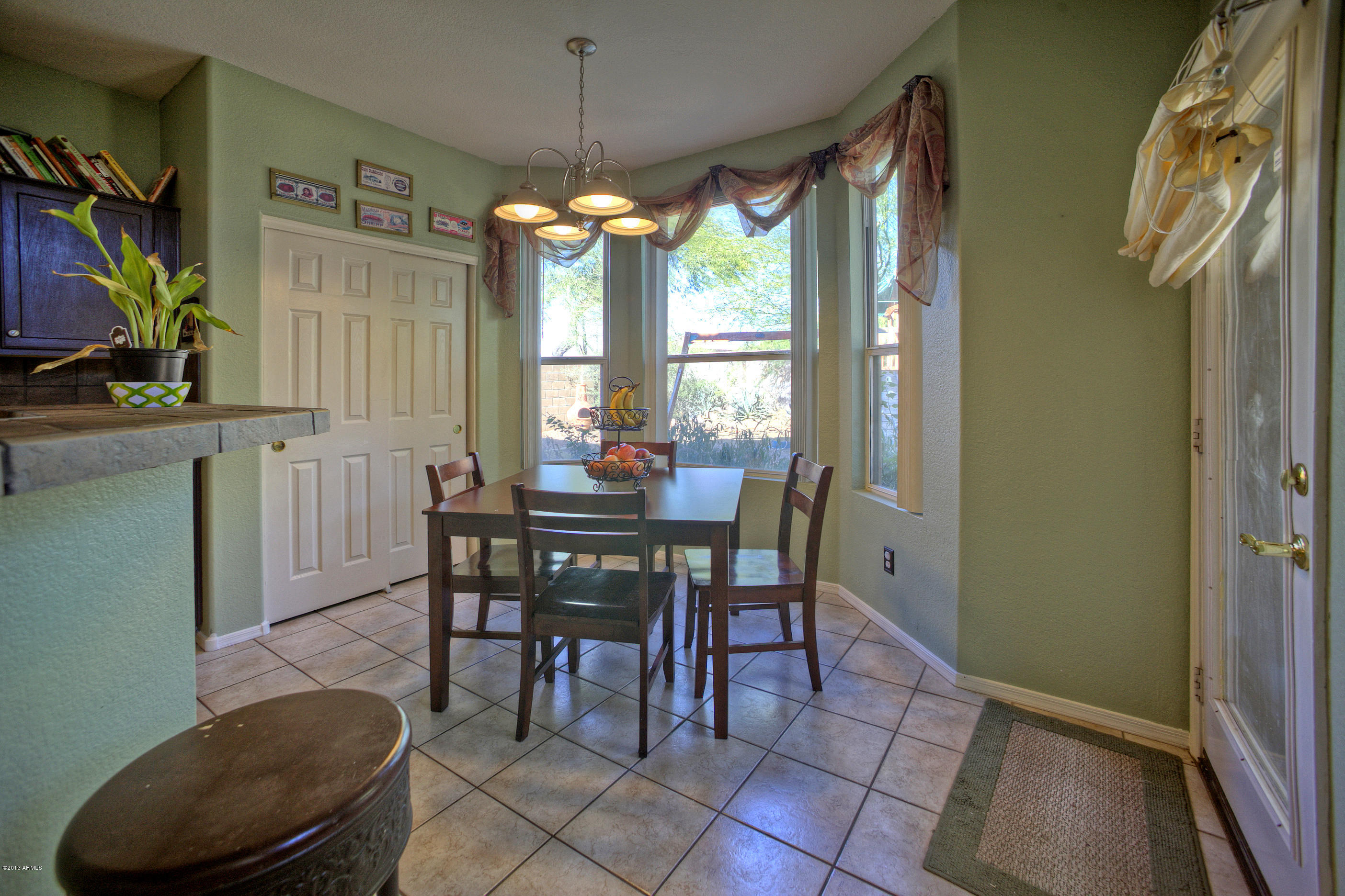 4510 East Rowel Road Phoenix, AZ 85050 - Photo 12 of 29 a view of a dining room with furniture window and outside view