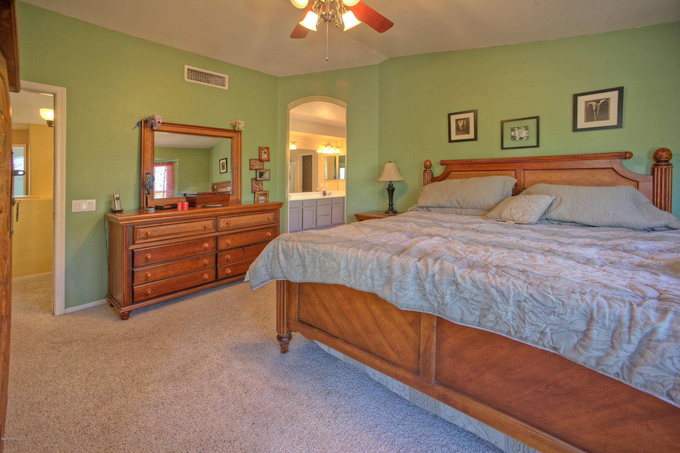 4510 East Rowel Road Phoenix, AZ 85050 - Photo 13 of 29 a bedroom with a bed and a chandelier