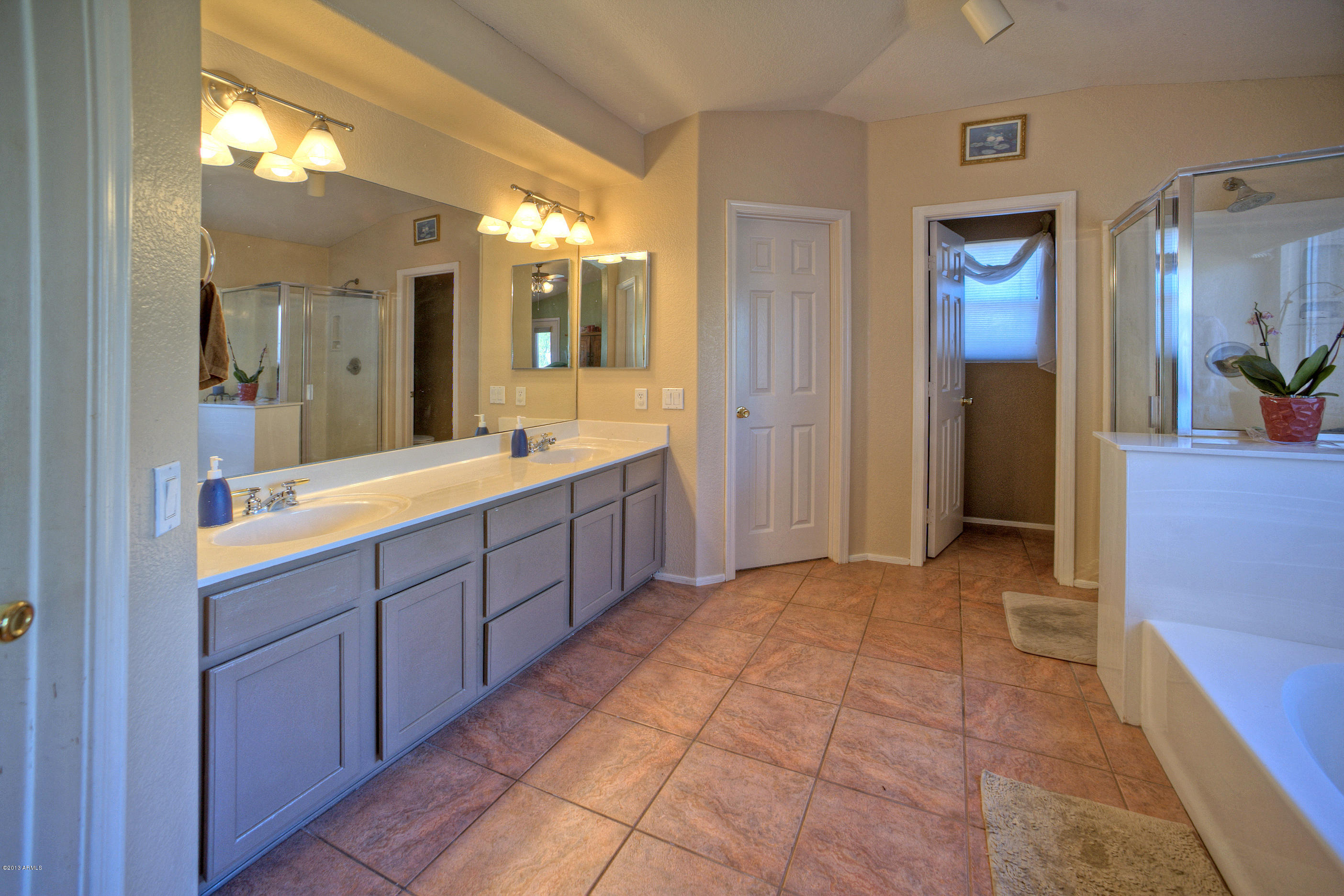 4510 East Rowel Road Phoenix, AZ 85050 - Photo 15 of 29 a large bathroom with a double vanity sink and a mirror
