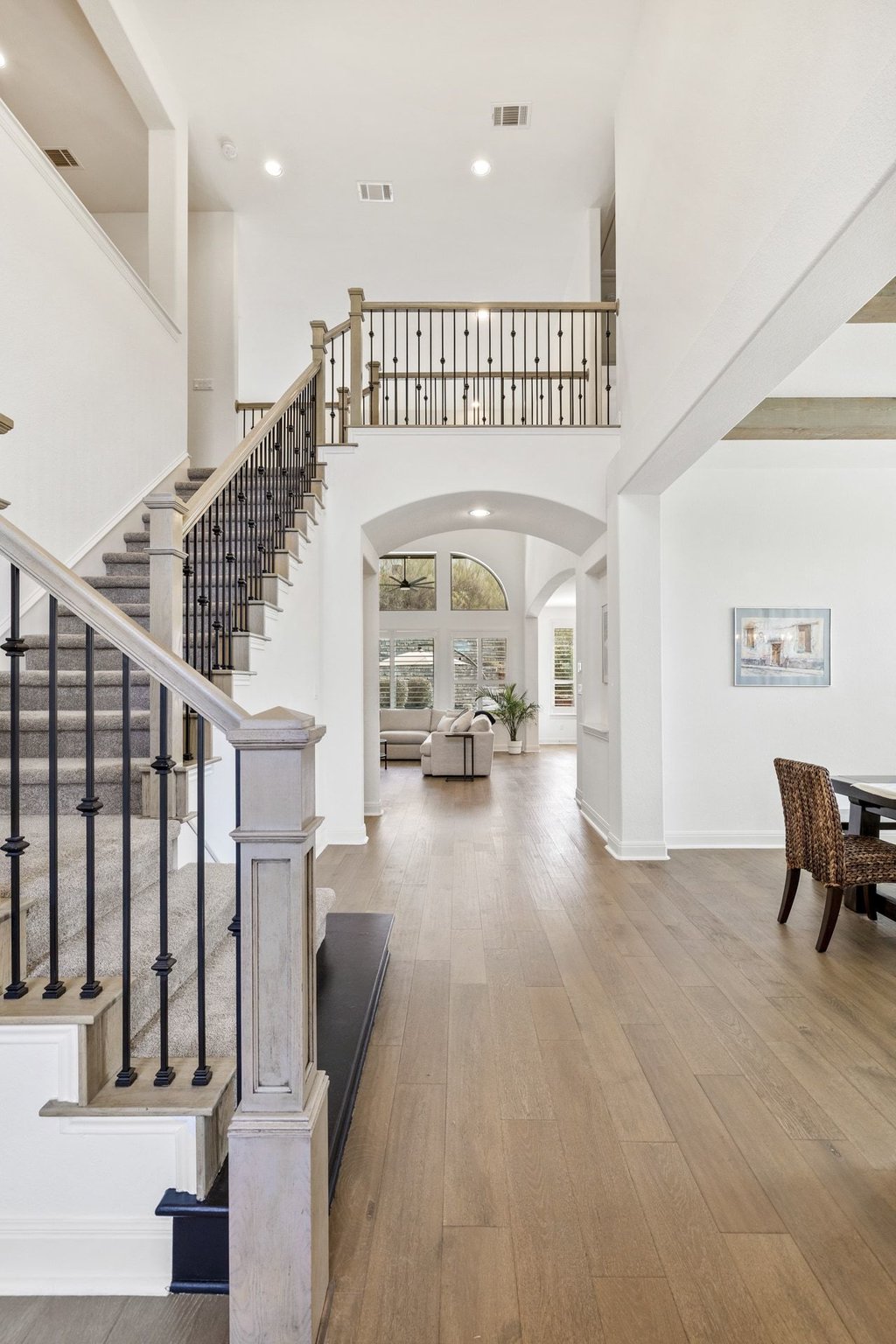 5812 Davenport Divide Road Austin, TX 78738 - Photo 5 of 40 A bright, open entry anchored by a sweeping staircase, creating a beautiful first impression for guests.