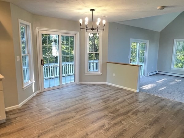 5 Winesap Way Ashland, MA 01721 - Photo 3 of 22 a view of an empty room with wooden floor and a window