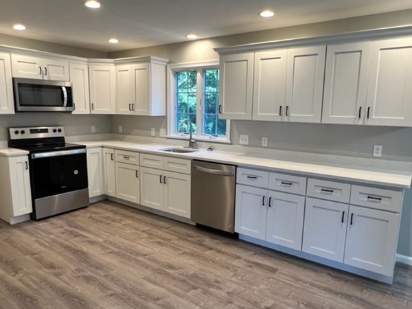 5 Winesap Way Ashland, MA 01721 - Photo 6 of 22 a kitchen with sink a microwave and cabinets