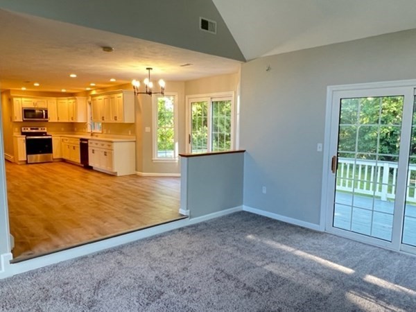 5 Winesap Way Ashland, MA 01721 - Photo 8 of 22 a view of an empty room with kitchen view and a window
