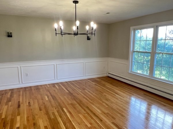 5 Winesap Way Ashland, MA 01721 - Photo 9 of 22 a view of an empty room with wooden floor and a window