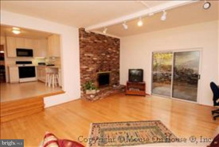 9211 Friars Road Bethesda, MD 20817 - Photo 10 of 30 Family Room w/ brick fireplace opens to patio