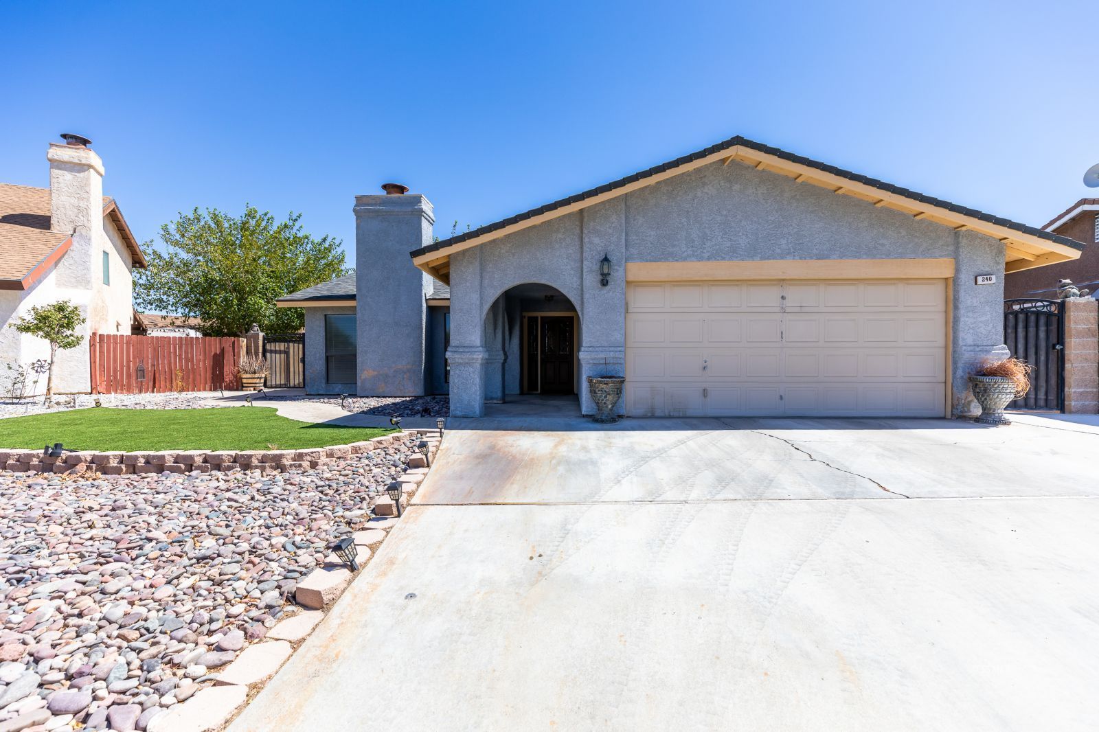 240 Richard Court Ridgecrest, CA 93555 - Photo 2 of 34 a front view of a house with a yard and garage