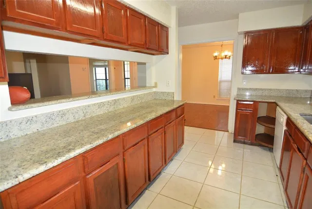 a kitchen with stainless steel appliances granite countertop a sink and cabinets