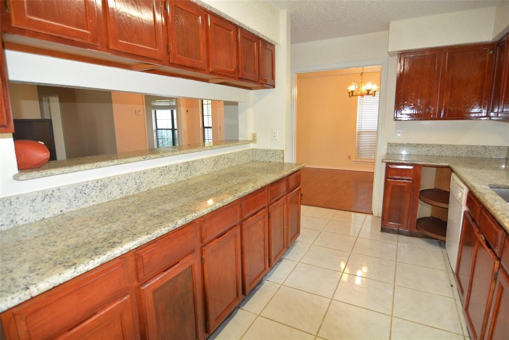 210 Apollo Road Garland, TX 75040 - Photo 11 of 27 a kitchen with stainless steel appliances granite countertop a sink and cabinets