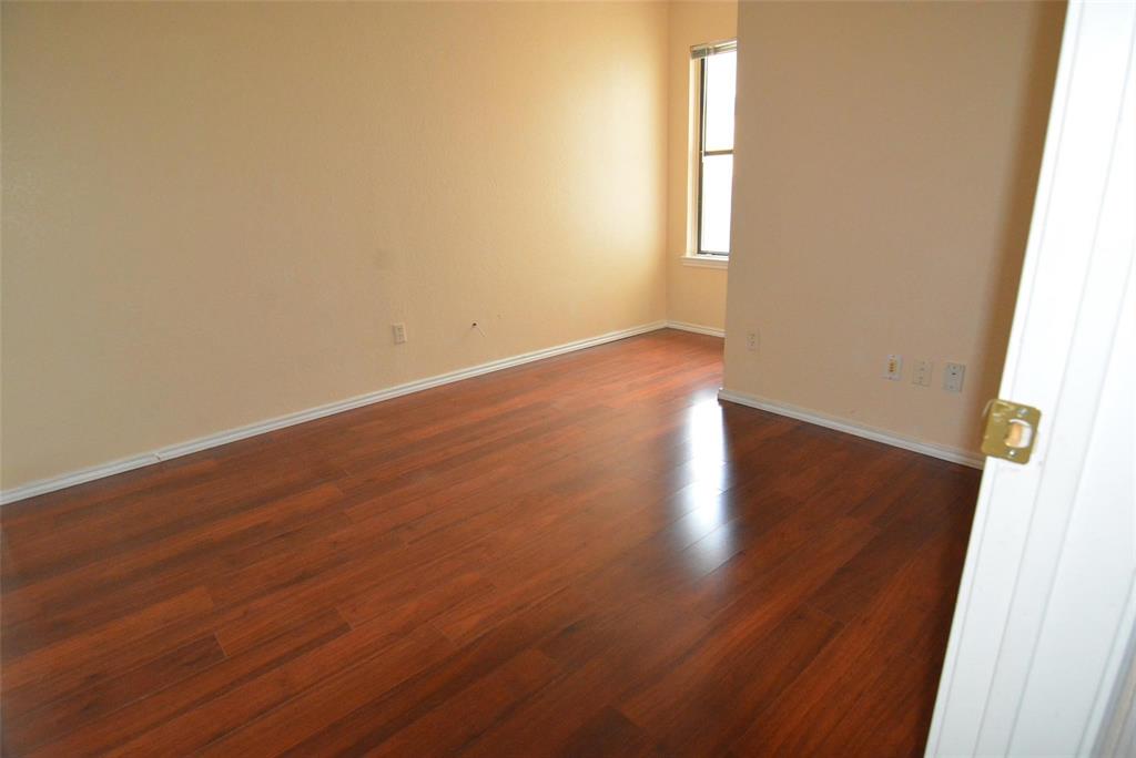 210 Apollo Road Garland, TX 75040 - Photo 16 of 27 an empty room with wooden floor and windows