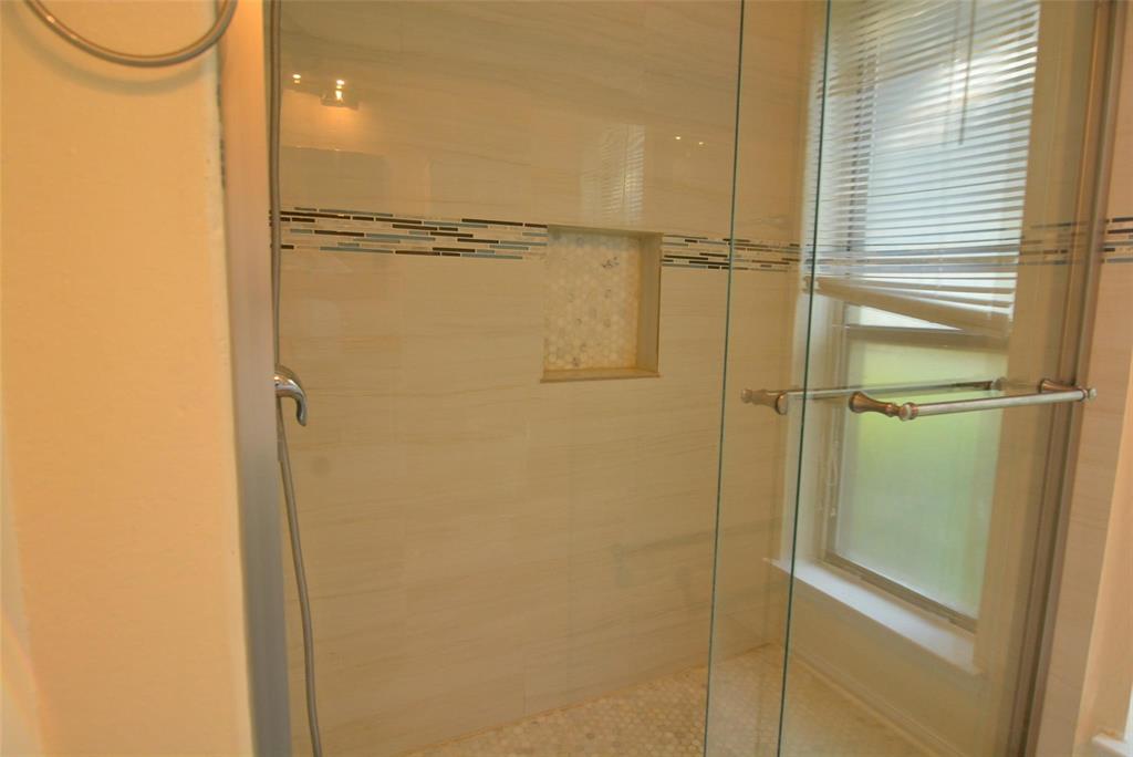 210 Apollo Road Garland, TX 75040 - Photo 19 of 27 a bathroom with a glass shower door
