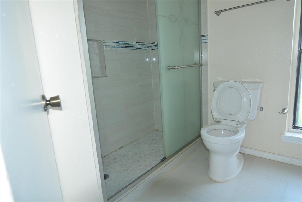 210 Apollo Road Garland, TX 75040 - Photo 22 of 27 a bathroom with a toilet sink and shower