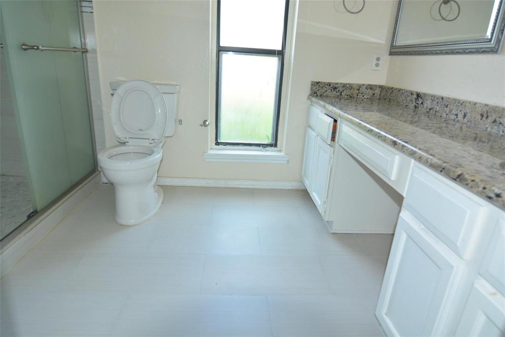 210 Apollo Road Garland, TX 75040 - Photo 23 of 27 a view of a bathroom with a sink and a toilet