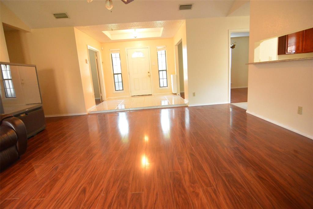 210 Apollo Road Garland, TX 75040 - Photo 25 of 27 a view of an empty room with wooden floor and a window