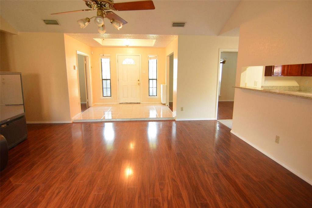 210 Apollo Road Garland, TX 75040 - Photo 26 of 27 a view of a livingroom with wooden floor