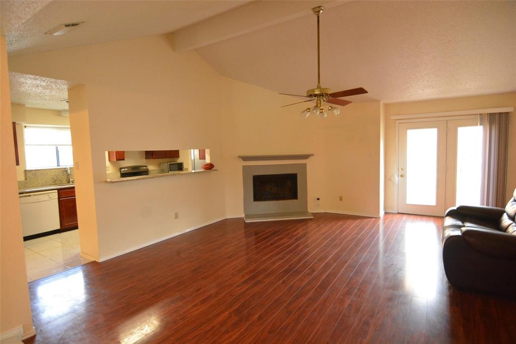 210 Apollo Road Garland, TX 75040 - Photo 8 of 27 a view of a kitchen with a stove wooden floor and a kitchen