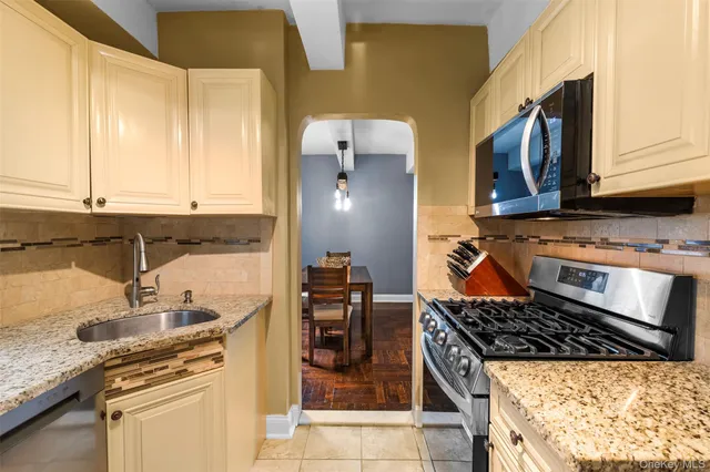 a kitchen with stainless steel appliances granite countertop a stove and a sink
