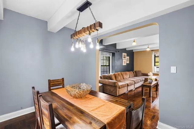 a living room with furniture a chandelier and a dining table