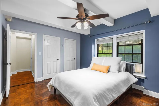 a bedroom with a bed and a large window