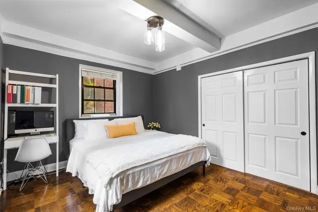 a bedroom with a bed a table and chair