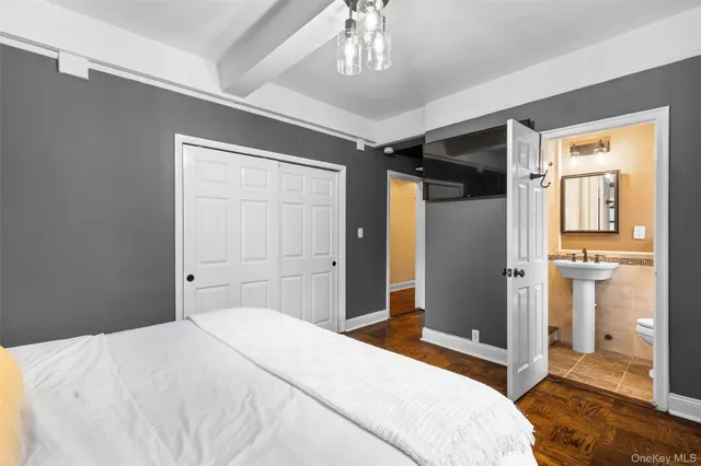 a bedroom with a bed and a mirror