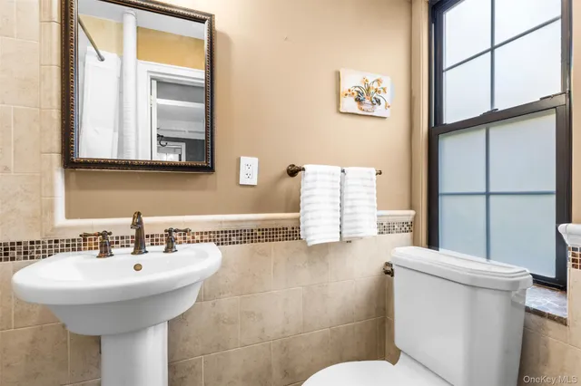 a bathroom with a sink a mirror and a toilet