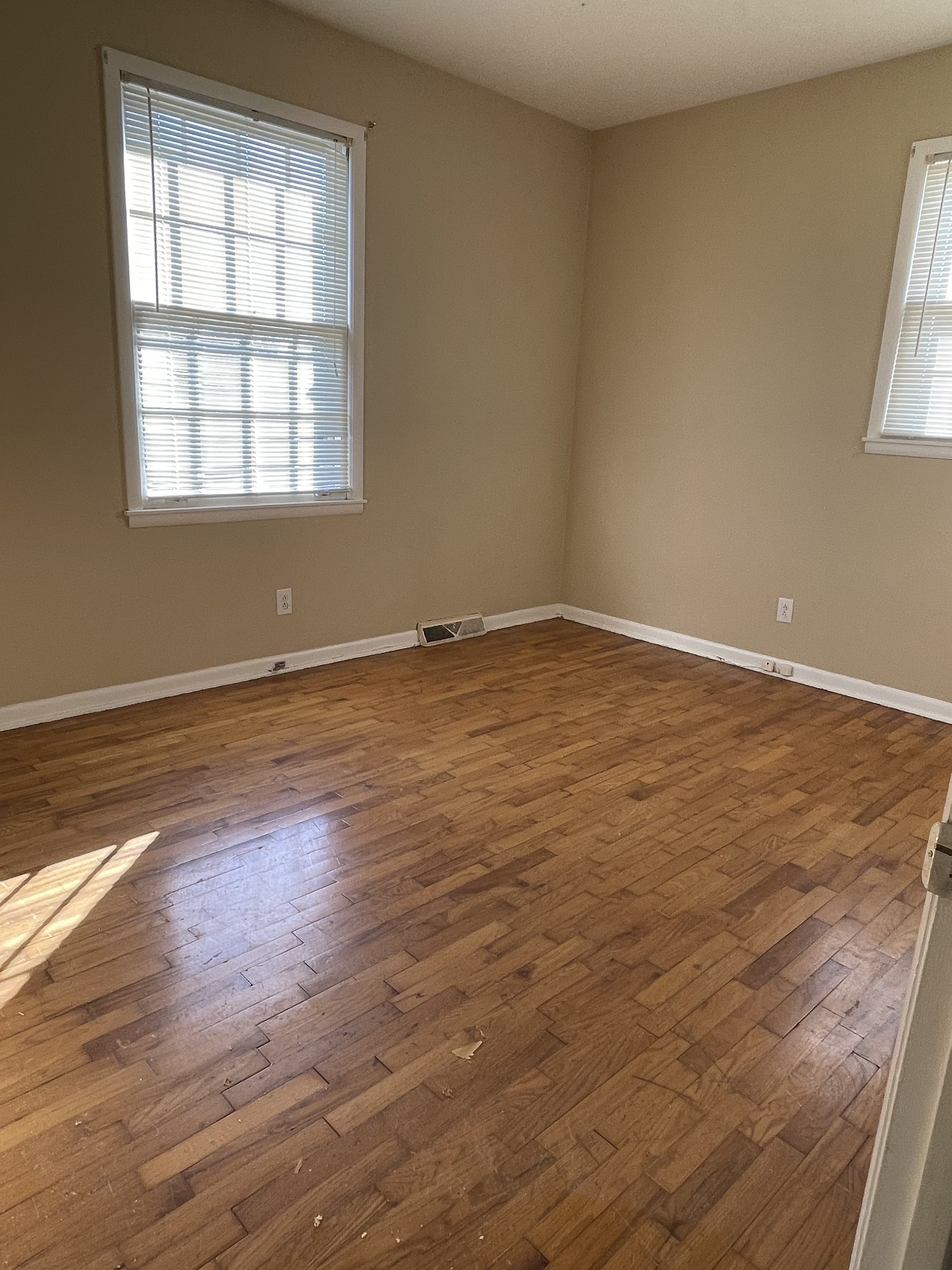 550 East Jefferson Street Pulaski, TN 38478 - Photo 16 of 23 an empty room with wooden floor and windows
